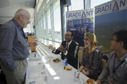 Man speaking to representatives from Gradiant at table