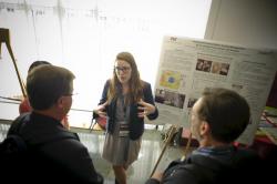 Woman presenting poster at conference