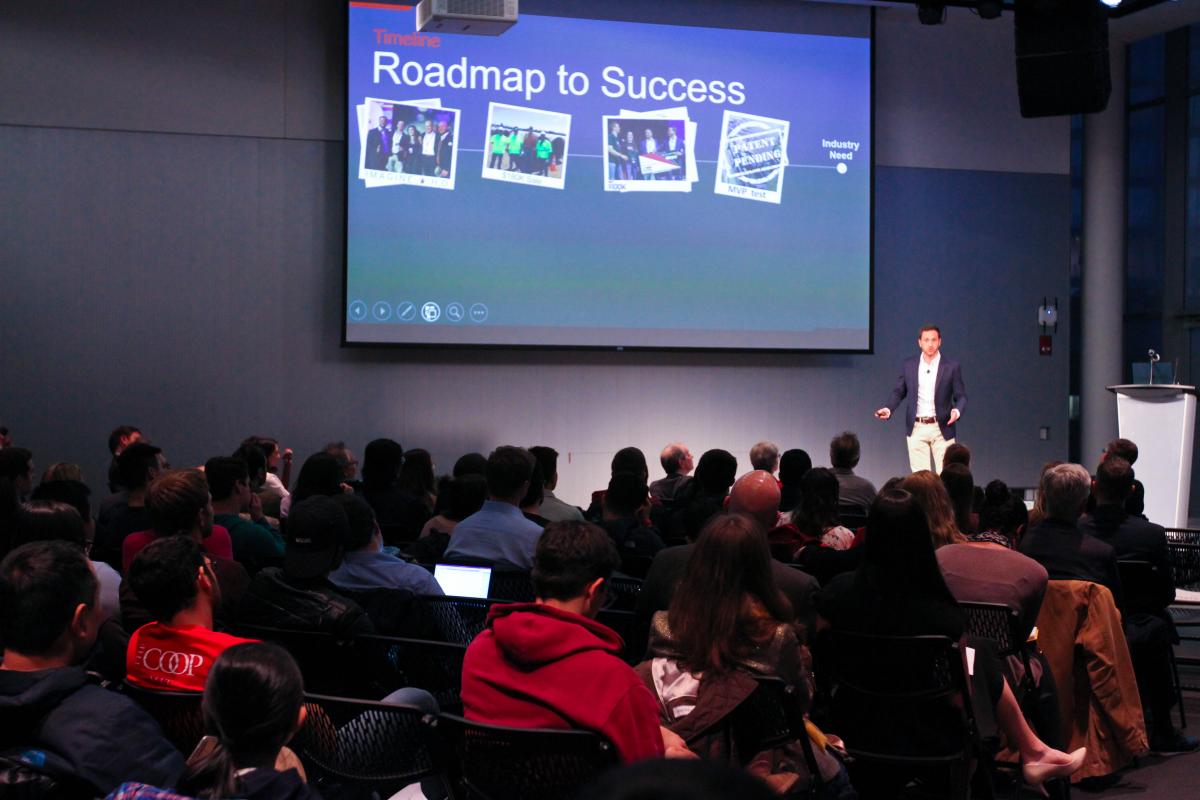 Speaker giving presentation titled "Roadmap to Success"