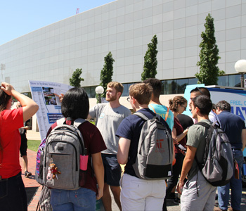 Andrew Bouma presenting Water Club poster to MIT students