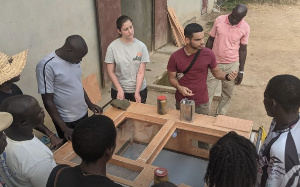 MIT student Aly Kombargi presents the brooder project to local farmers and community members in Cameroon
