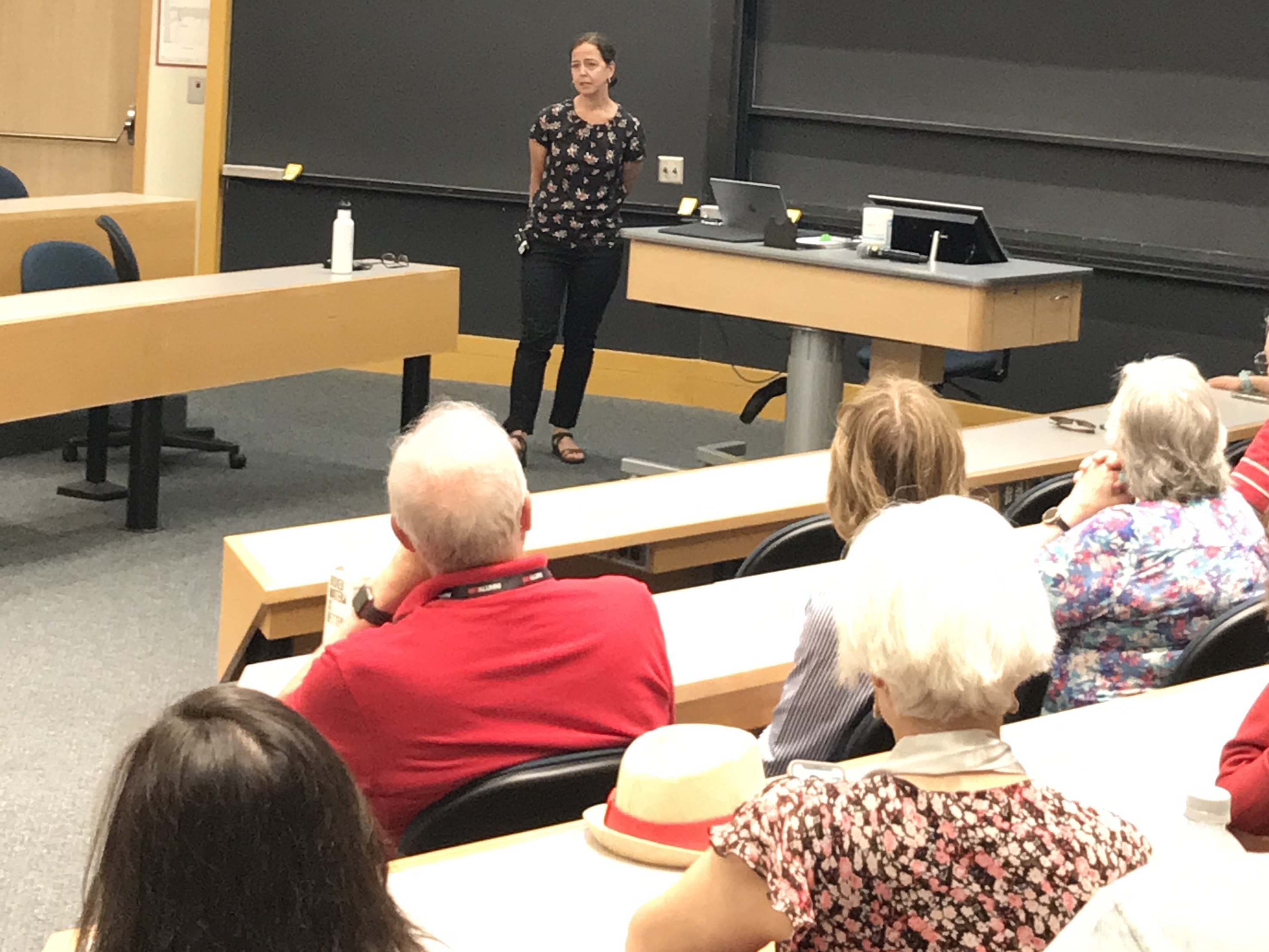 Gabriella Carolini presenting in front of a lecture hall of people