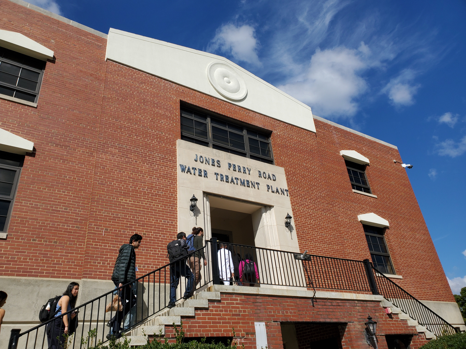 Travel grantees walking up steps to Jones Ferry Road Water Treatment Plant.