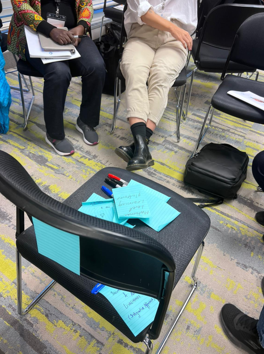 Blue sticky notes stuck on a black chair from a collaborative session at the conference.