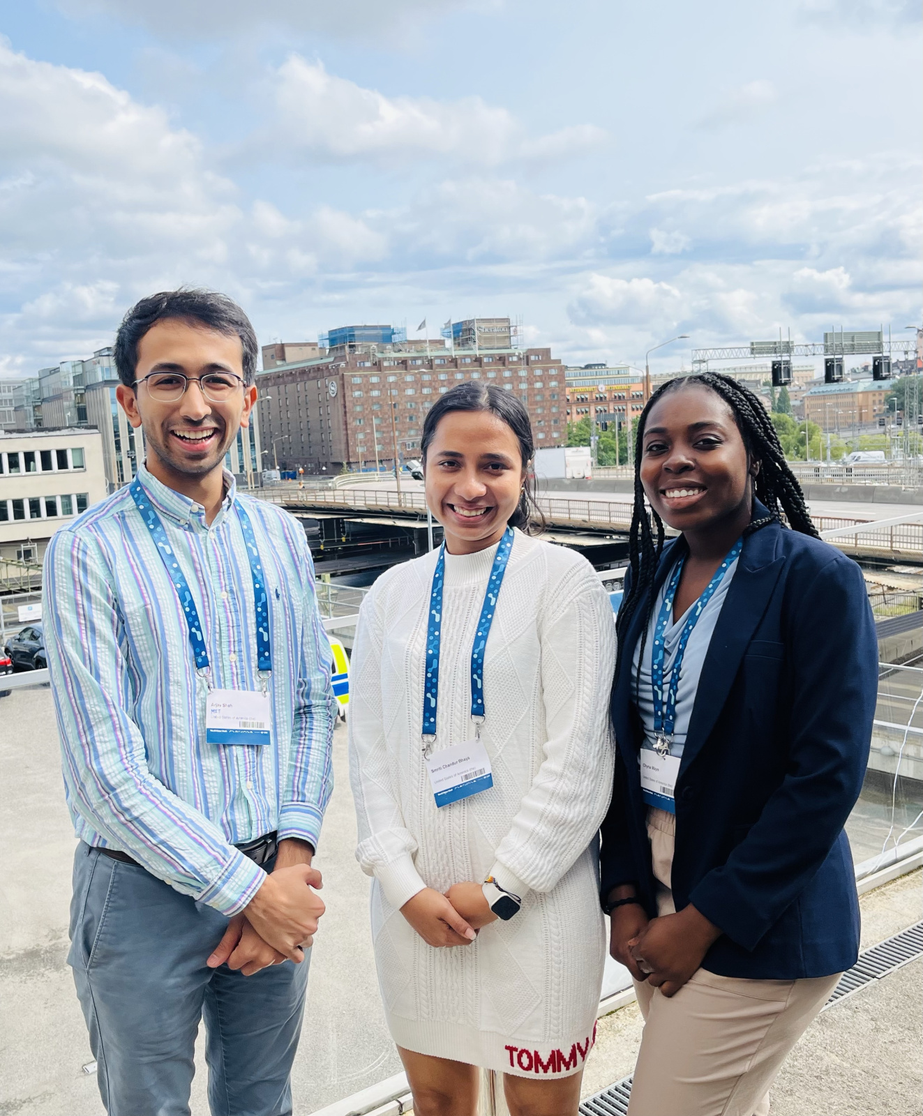 From left to right: Arjav Shah, Smriti Bhaya, and Chyna Mays standing in front of Stockholm buildings