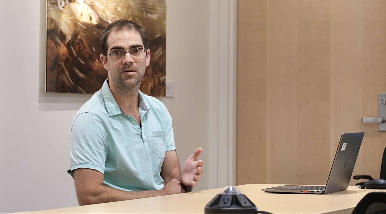 Danny Badger giving a presentation in a conference room setting