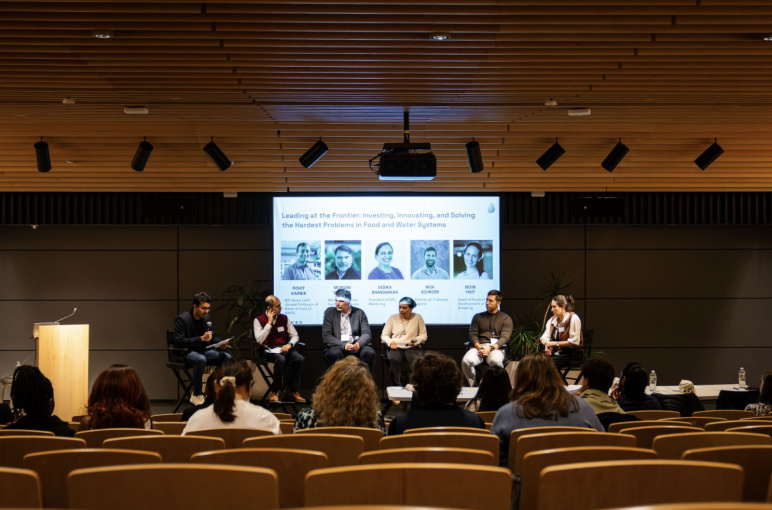 Panel of judges sit at the front of the room
