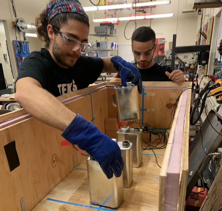 Ahmad Zakka and Aly Kombargi prepare a beeswax thermal battery test