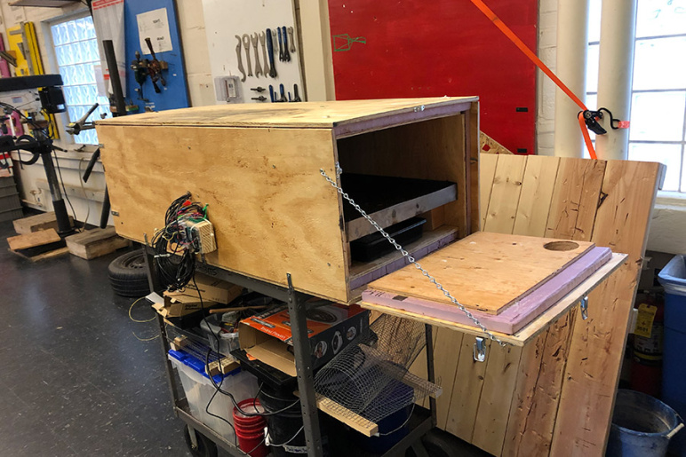 Wooden box prototype of upgraded chicken brooder in the lab