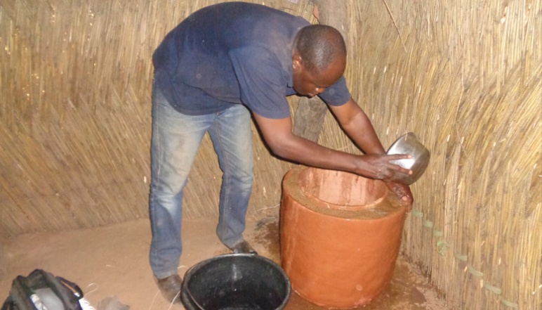 Man pouring water on pot