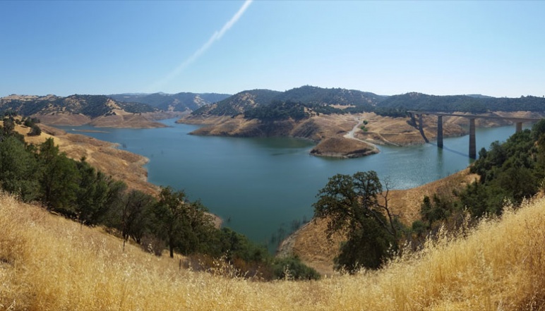 Large basin of water with aqueduct in the distance