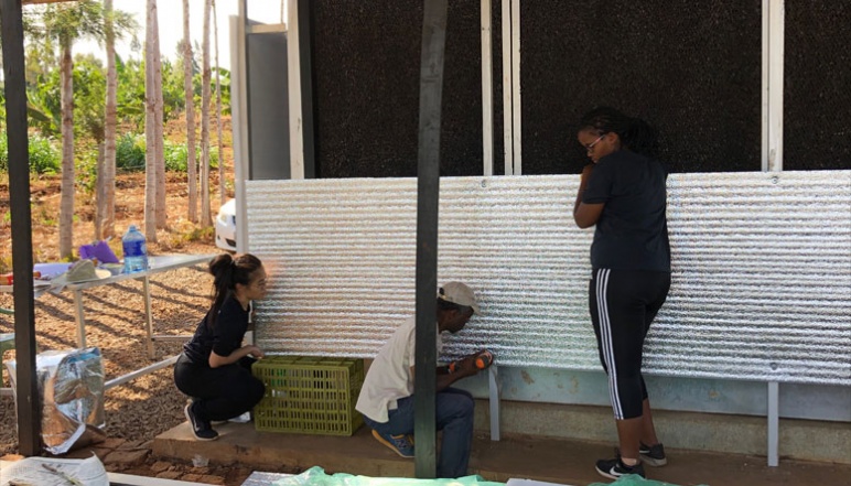 Umubyeyi, Luu, and El-Yahkim  building charcoal ECC with reflective panels 
