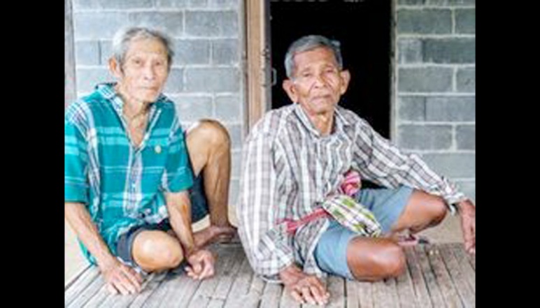 Two rice farmers sitting on porch