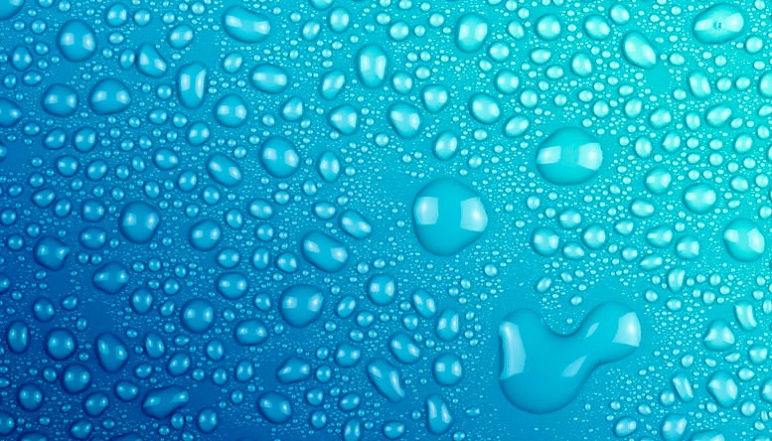 Water droplets resting on a blue surface