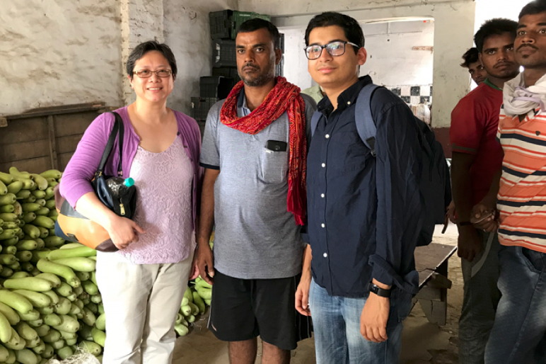 A women and two men stand together in India