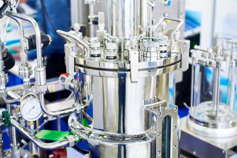 A silver, metallic machine on a lab bench.