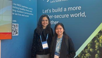 Priyanka and Hao in front of blue Xylem poster