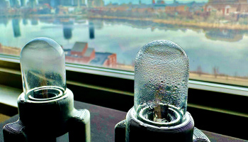 Ultrasonic water harvesting device on a windowsill overlooking Boston and the Charles River