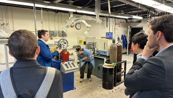 A group of people watching an experiment being done in a lab