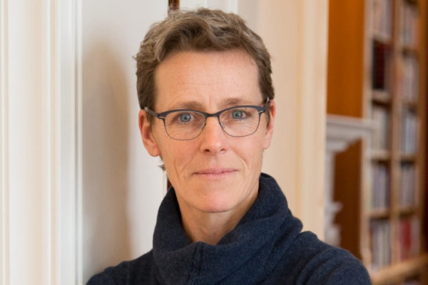 Kate Brown stands in a blue sweater.