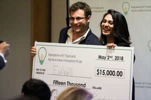 Two winners holding giant check