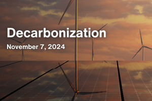 An event poster, titled "Decarbonization" on a background of wind turbines and solar panels, taking place on November 7, 2024. 