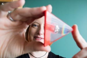 Noelle Selin with clear cone with rainbow inside in front of face