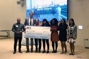 Winners of water prize holding giant check