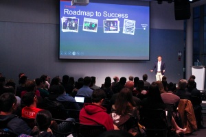 Speaker giving presentation titled "Roadmap to Success"