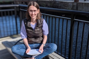 Andrea Beck sitting by river