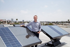 Cory Friesen next to solar panels