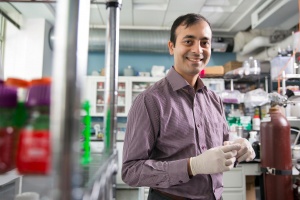 Man stands in lab setting smiling