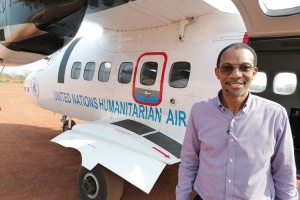 Man stands in front of humanitarian airplane
