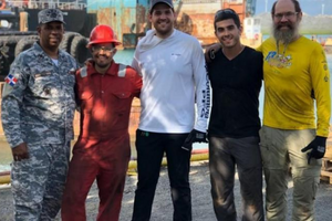 Five men standing on dock in the Carribbean, including Alex Slocum, Andrés Bisonó León, and Luke Gray 