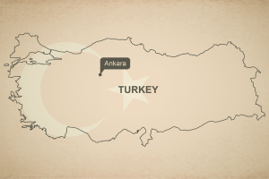 A map of Turkey in a beige background with the shade of their flag 