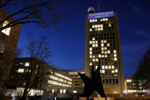 MIT students projected a climate clock onto the university's Green Building. The clock counts down to the projected time that Earth will have warmed 1.5 degrees Celsius from preindustrial levels using unconventional metrics like Boston sporting events.