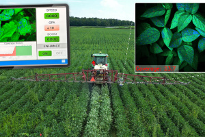 A tractor sprays crops in a field using precision agriculture technology, with an inset showing a digital interface tracking spray coverage and plant health.