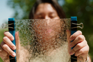 Person holding fish "plastic" in front of their face
