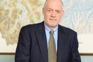 Tim Swager in a suit in front of a painting