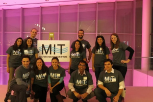 Water Club members gathered around MIT Water Club prize, pink background