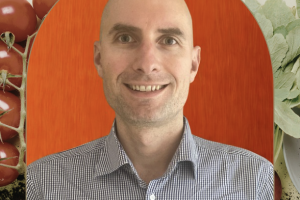 Thomas headshot with vegetable image behind him