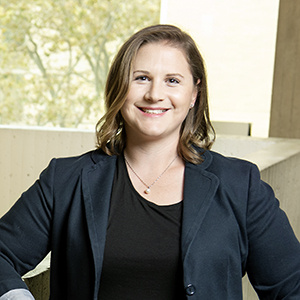 Ariel Furst standing, smiling with black shirt and blazer