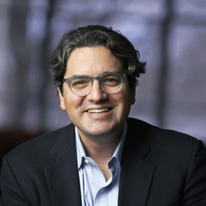Giovanni Traverso in a shirt and jacket with glasses