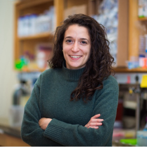 Tami Lieberman with arms folded in front of chest standing in her lab