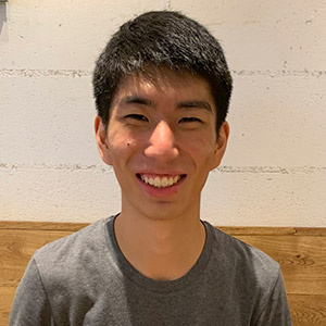 Headshot of James Zhang, smiling and wearing a gray T-shirt