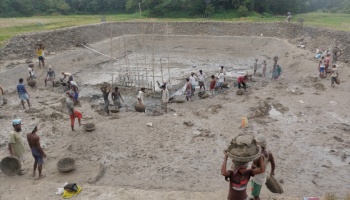 Villagers gathering mud in baskets