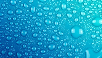 Water droplets resting on a blue surface