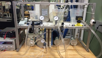 Series of tubes, beakers, and instruments set up for experiment