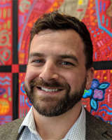 White man with brown beard and mustache