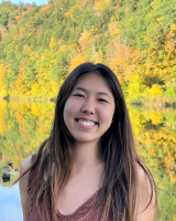 Adela Chenyang Li outside in front of water and trees